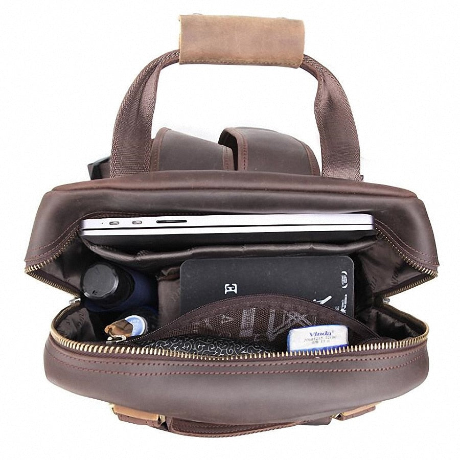 The Gaetano | Large Leather Backpack Camera Bag with Tripod Holder, showcasing a laptop, tailored compartments, and logo detail, ideal for photographers.