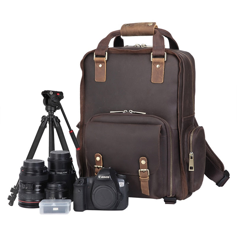 The Gaetano Large Leather Backpack Camera Bag with Tripod Holder, featuring a camera, tripod, and tailored compartments for a DSLR and lenses.