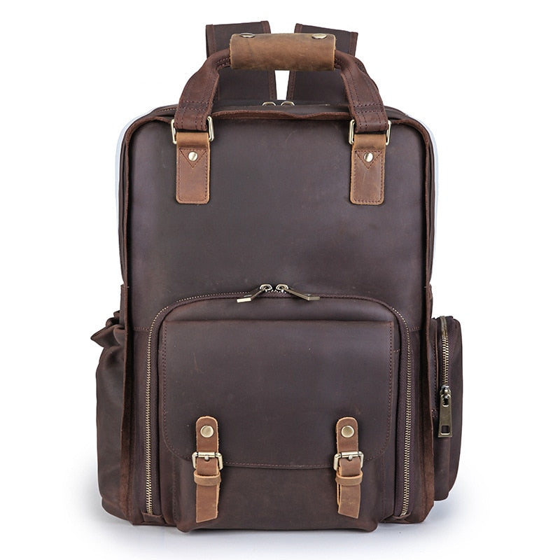 The Gaetano Large Leather Backpack Camera Bag with Tripod Holder features brown leather, secure compartments, and adjustable straps, ideal for photographers on the move.