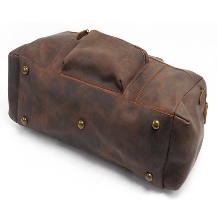 The Asta Weekender | Handcrafted Leather Duffle Bag featuring gold rivets, durable crazy horse leather, ergonomic design with adjustable strap, and multiple compartments for organized storage.